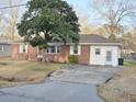 A charming brick house with a well-kept yard and driveway, presenting a welcoming and classic curb appeal at 228 Jean Wells Dr, Goose Creek, SC 29445