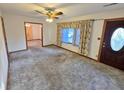 Bright living room featuring large windows, neutral carpet, and an open doorway to an adjoining room at 228 Jean Wells Dr, Goose Creek, SC 29445