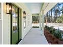 Inviting front porch with a green door, lantern lighting, and ample space to relax at 2725 Starfish Dr, Johns Island, SC 29455