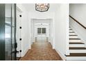 Hallway with brick floors and stairs leading to a room filled with natural light at 2725 Starfish Dr, Johns Island, SC 29455