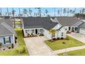 The home's pleasing exterior is complimented by a lush lawn, mature palm tree, and a lengthy driveway at 357 Tupelo Lake Dr, Summerville, SC 29486
