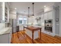 Bright kitchen featuring white cabinetry, stainless appliances, and a large center island with wood countertop at 3699 Codorus Ct, Mount Pleasant, SC 29466