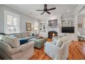 Comfortable living room with fireplace, built-in shelving, plush seating, and bright windows at 3699 Codorus Ct, Mount Pleasant, SC 29466