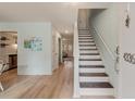 Bright entryway with stairs, wood flooring, and fresh paint, leading to other rooms at 4336 Purdue Dr, North Charleston, SC 29418