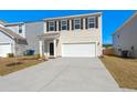 Daytime view of a two-story house with a two-car garage and a well-maintained front yard at 4368 Ocean Farm Dr, Summerville, SC 29485