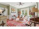 Cozy living room with hardwood floors, a fireplace, and bright windows providing natural light at 48 Montagu St # B, Charleston, SC 29401