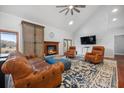 Cozy living room with a stone fireplace, vaulted ceilings, and rich hardwood floors at 4801 Coon Club Rd, Meggett, SC 29449