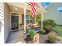 Inviting covered front porch with chairs and plants, creating a cozy and welcoming entrance to the home at 5024 Wapiti Way, Hollywood, SC 29449