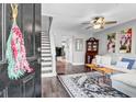 Inviting living room featuring a cozy seating area, ceiling fan, staircase, and stylish decor at 507 Stinson Dr # 5E, Charleston, SC 29407