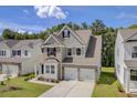Inviting two-story home with a two-car garage, brick accents, and a lovely front lawn at 525 Verdi Dr, Summerville, SC 29486