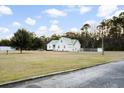 Charming home with a metal roof and well-maintained front lawn at 5529 Golden Rice Ln, Ravenel, SC 29470