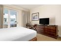Bedroom with balcony access features a desk and flatscreen television at 5804 Palmetto Dr # A-208, Isle of Palms, SC 29451