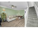 Bright living room featuring a comfortable sofa, hardwood flooring and stairs to the next level at 6244 Lucille Dr # B, North Charleston, SC 29406