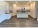 Modern kitchen with a center island, granite countertops, stainless steel appliances and sleek new floors at 744 Pisces Ln, Summerville, SC 29486