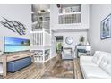 Bright, open living room features vaulted ceilings, a cozy fireplace, and modern decor at 8120 Shadow Oak Dr, North Charleston, SC 29406