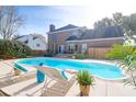 Backyard pool area features a spacious deck, lounge chairs, and a privacy fence at 904 Watermelon Run, Charleston, SC 29412