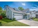 Charming two-story home with attached garage and landscaped yard at 9981 Winged Elm St, Ladson, SC 29456