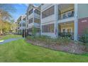 Beautiful condo building with lush lawns, gated entrances, and relaxing screened in balconies for outdoor living at 1025 Riverland Woods Pl # 801, Charleston, SC 29412