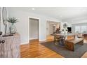 Open-concept dining area with hardwood floors, modern table, bench and natural light at 1079 Lockhart St, North Charleston, SC 29405