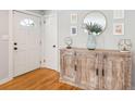 Inviting entryway featuring wood floors, console table, modern decor, and a front door at 1079 Lockhart St, North Charleston, SC 29405