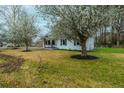 Landscaped lawn surrounding this beautiful home with blossoming trees providing shade at 1114 Margaret Dr, Ladson, SC 29456