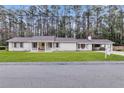 Charming single-story home with a brick exterior, inviting entrance and well-manicured lawn and trees in the background at 123 Sharon Dr, Walterboro, SC 29488