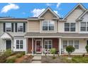 Charming townhomes featuring landscaped front yards and covered front porches with seating areas at 138 Taylor Cir, Goose Creek, SC 29445