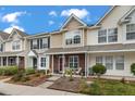 Charming townhomes featuring landscaped front yards and covered front porches with seating areas at 138 Taylor Cir, Goose Creek, SC 29445