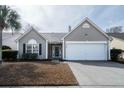 Inviting single-story home with a neat front lawn, attached garage, and classic architectural details at 1529 Wellesley Cir, Mount Pleasant, SC 29466