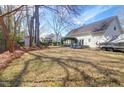 Spacious backyard featuring mature trees, a boat on a trailer, and a small deck with outdoor furniture at 1656 Lauda Dr, Mount Pleasant, SC 29464