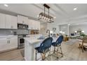 Stylish kitchen island with modern lighting fixtures and seating for casual dining at 1744 Pinckney Park Dr, Charleston, SC 29407