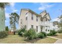 Beautiful two-story home with a welcoming porch and well-maintained lawn at 1878 Carolina Bay Dr, Charleston, SC 29414
