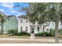 Charming two-story home featuring a welcoming front porch and lush, green landscaping at 1878 Carolina Bay Dr, Charleston, SC 29414