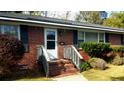 Inviting front porch with brick steps and white railing, leading to the front door at 1902 Morgan Ave, North Charleston, SC 29406