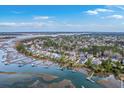 Aerial view of a waterfront community showing waterfront houses and boats docked along the shore at 2040 Ashburton Way, Mount Pleasant, SC 29466