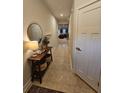Inviting hallway with tile floors, decor, and a glimpse into the kitchen at 205 Grand Palm Ln, Summerville, SC 29485