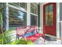 Cozy front porch with red decorative bench, offering a welcoming entrance to the home at 2690 Park W Blvd, Mount Pleasant, SC 29466