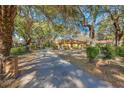 Charming home with mature trees lining the driveway and a well-maintained yard at 29 Wendy Lane, Charleston, SC 29407