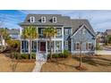 Beautifully landscaped two-story home with a spacious front porch and classic architectural details at 2975 Yachtsman Dr, Mount Pleasant, SC 29466