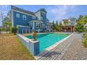 Inviting backyard pool area with outdoor kitchen, pergola, and beautiful stone patio at 2975 Yachtsman Dr, Mount Pleasant, SC 29466