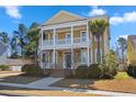 Charming two-story home featuring a double porch, landscaped yard, and palm trees at 301 Forsythia Ave, Summerville, SC 29483
