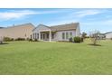 Spacious, well-maintained backyard featuring a covered porch and ample green space at 303 Sand Dune Trl, Summerville, SC 29486