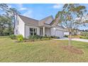 Lovely home with great curb appeal featuring a well-groomed lawn and colorful flower beds at 3109 Hugh Bennett Dr, Johns Island, SC 29455