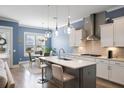 Beautiful kitchen with modern island, stainless hood, lighting, and eat-in breakfast area at 3125 Sturbridge Rd, Mount Pleasant, SC 29466