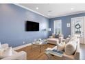 Comfortable living room with lots of seating, a large TV, natural light and neutral colors at 3125 Sturbridge Rd, Mount Pleasant, SC 29466