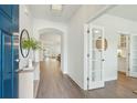 Bright foyer with hardwood floors, archway, and glass-paned door providing a view into a dining or living room at 4045 Oxeye Loop, Johns Island, SC 29455