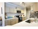 Updated kitchen with stainless steel appliances, quartz countertops, and ample cabinet space at 45 Sycamore Ave # 634, Charleston, SC 29407