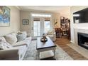 A spacious living room with a fireplace, comfortable seating, and view of the patio at 45 Sycamore Ave # 634, Charleston, SC 29407