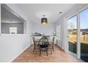 Bright dining area with a sliding glass door to backyard and modern light fixture at 521 Holiday Dr, Summerville, SC 29483