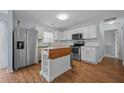 Bright kitchen featuring stainless steel appliances, white cabinetry, and a kitchen island at 521 Holiday Dr, Summerville, SC 29483